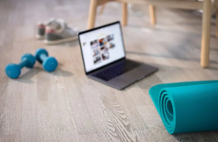 laptop in middle of home workout equipment scaled