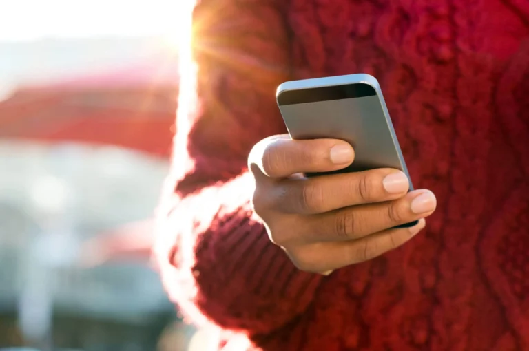 person holds mobile phone scaled