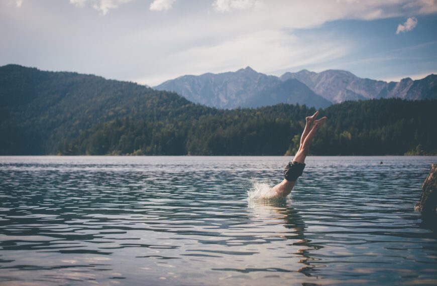 person swims in lake scaled