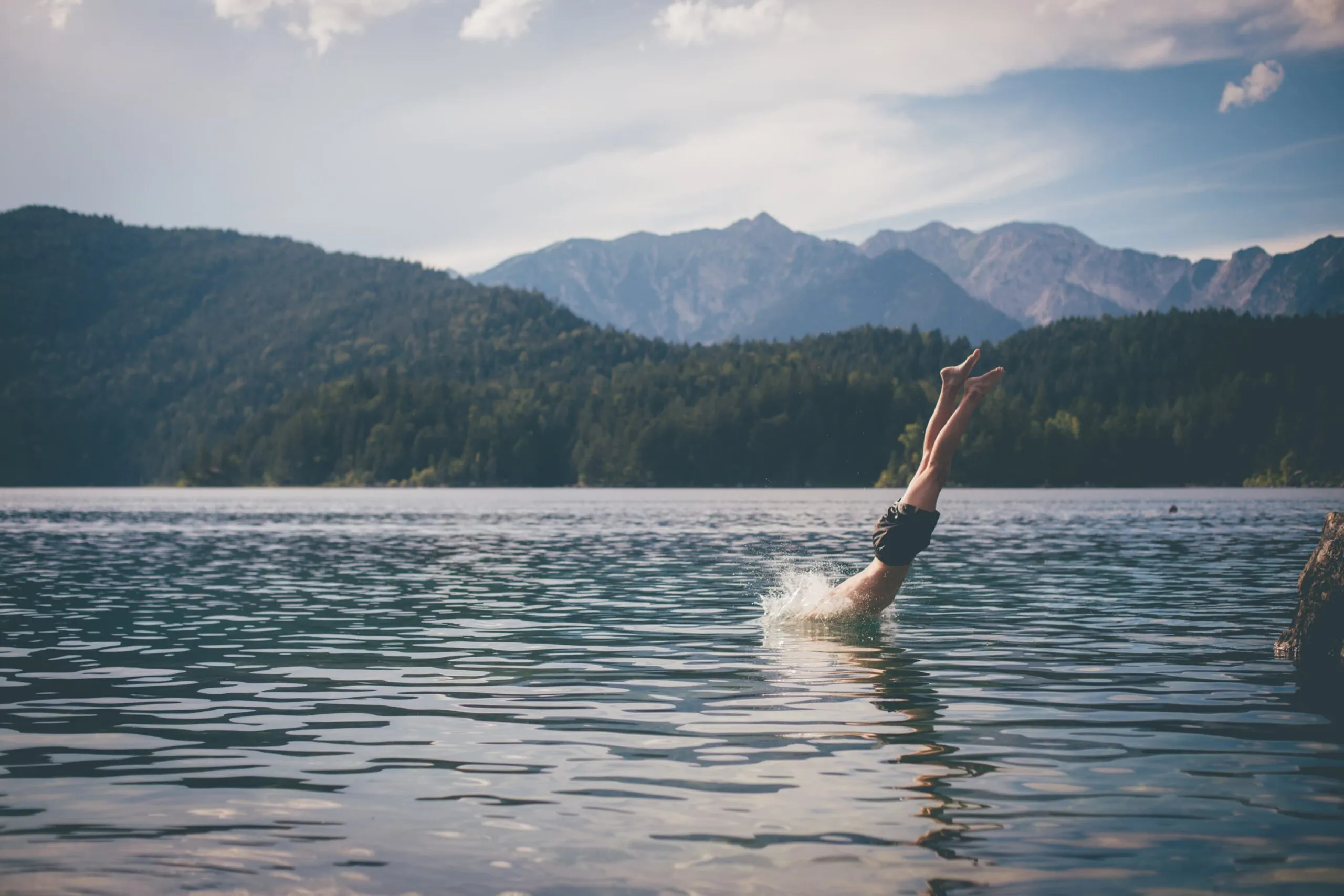 person swims in lake scaled