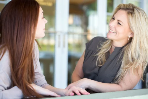 two women laughing scaled