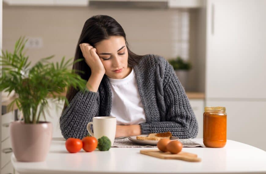 woman looking at food on table scaled