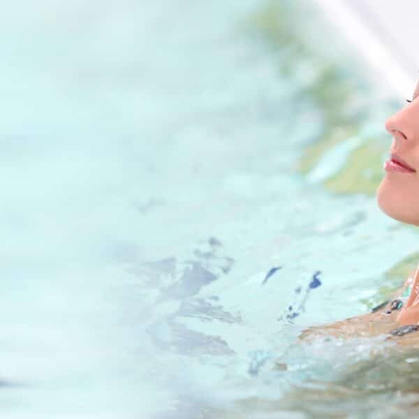 woman relaxes in swimming pool scaled