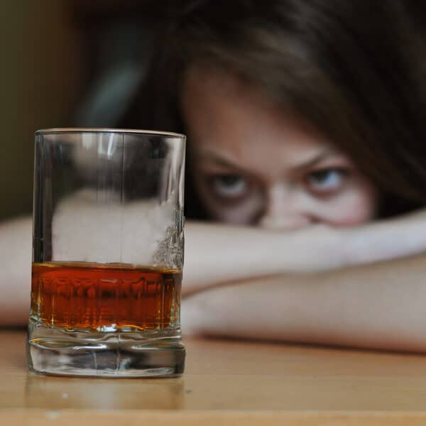 woman stares at alcoholic drink