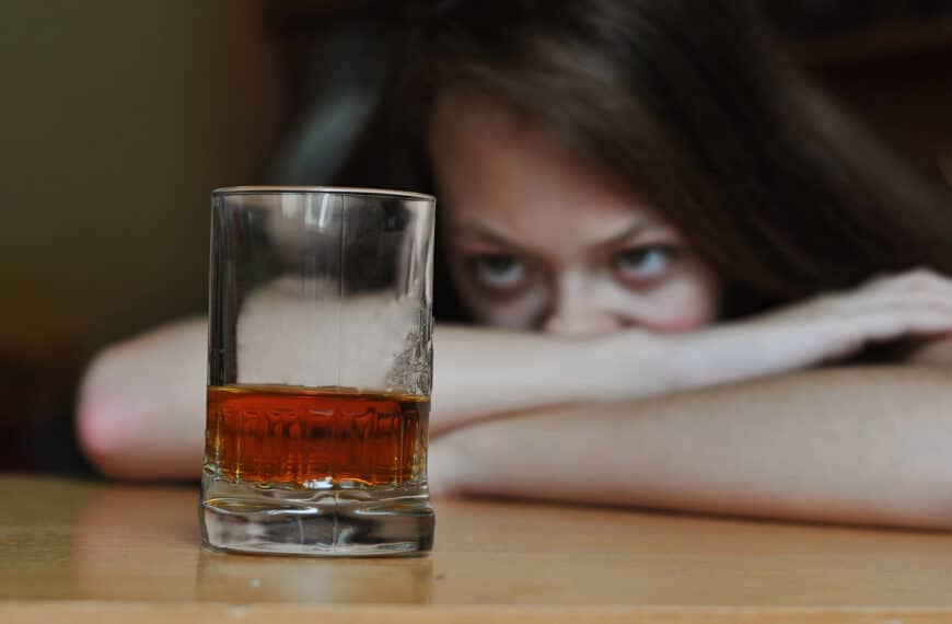 woman stares at alcoholic drink