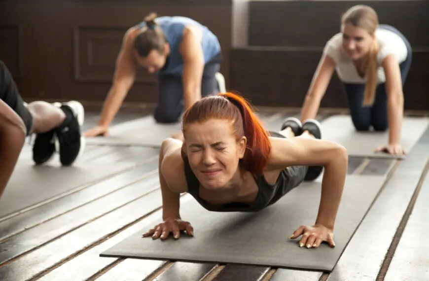 woman straining holdig a plank scaled
