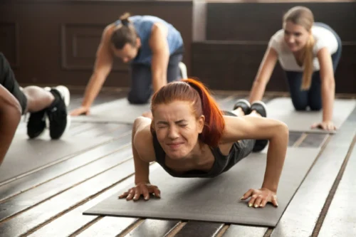 woman straining holdig a plank scaled