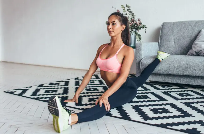 woman stretches at home scaled