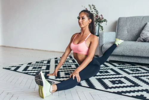 woman stretches at home scaled