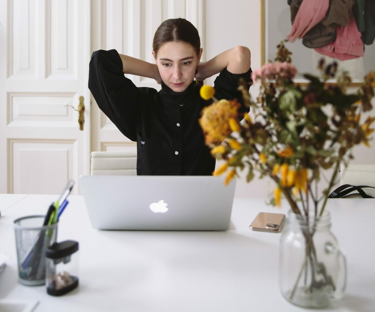 woman stretches at laptop