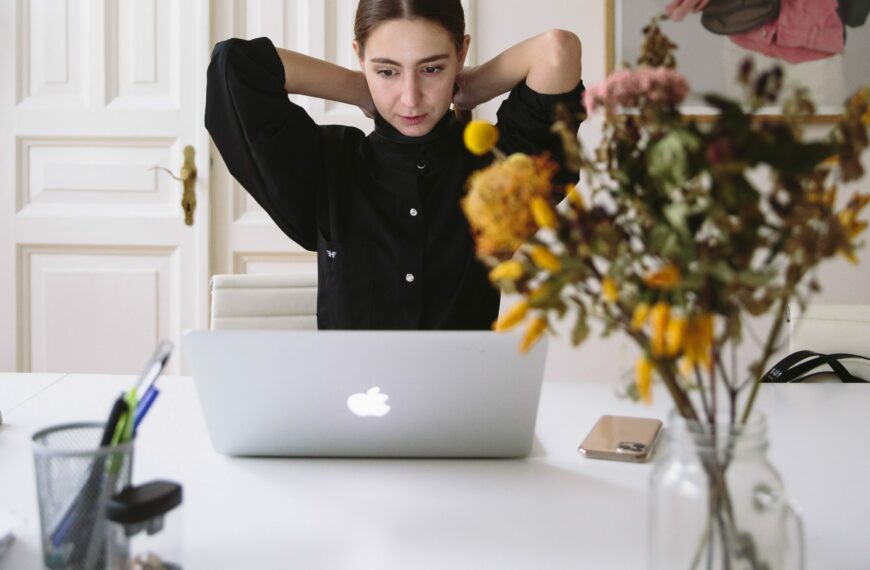 woman stretches at laptop