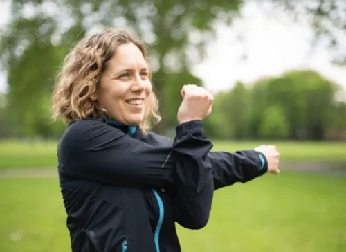 woman warms up with arm exercise