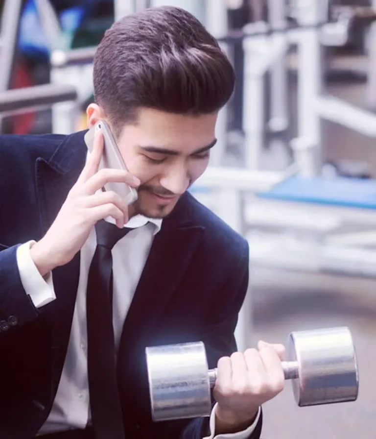 man in suit holding dumbbell