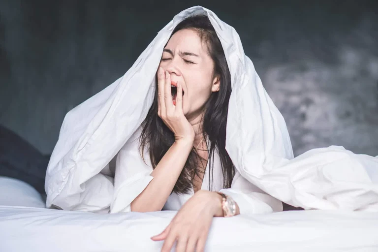 sleepy woman under covers