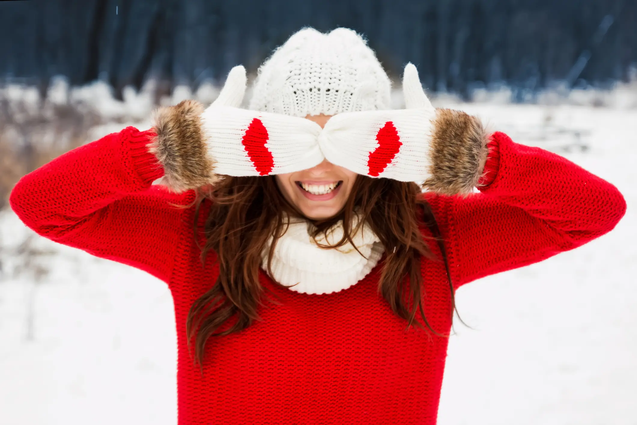 Woman covering eyes in the snow