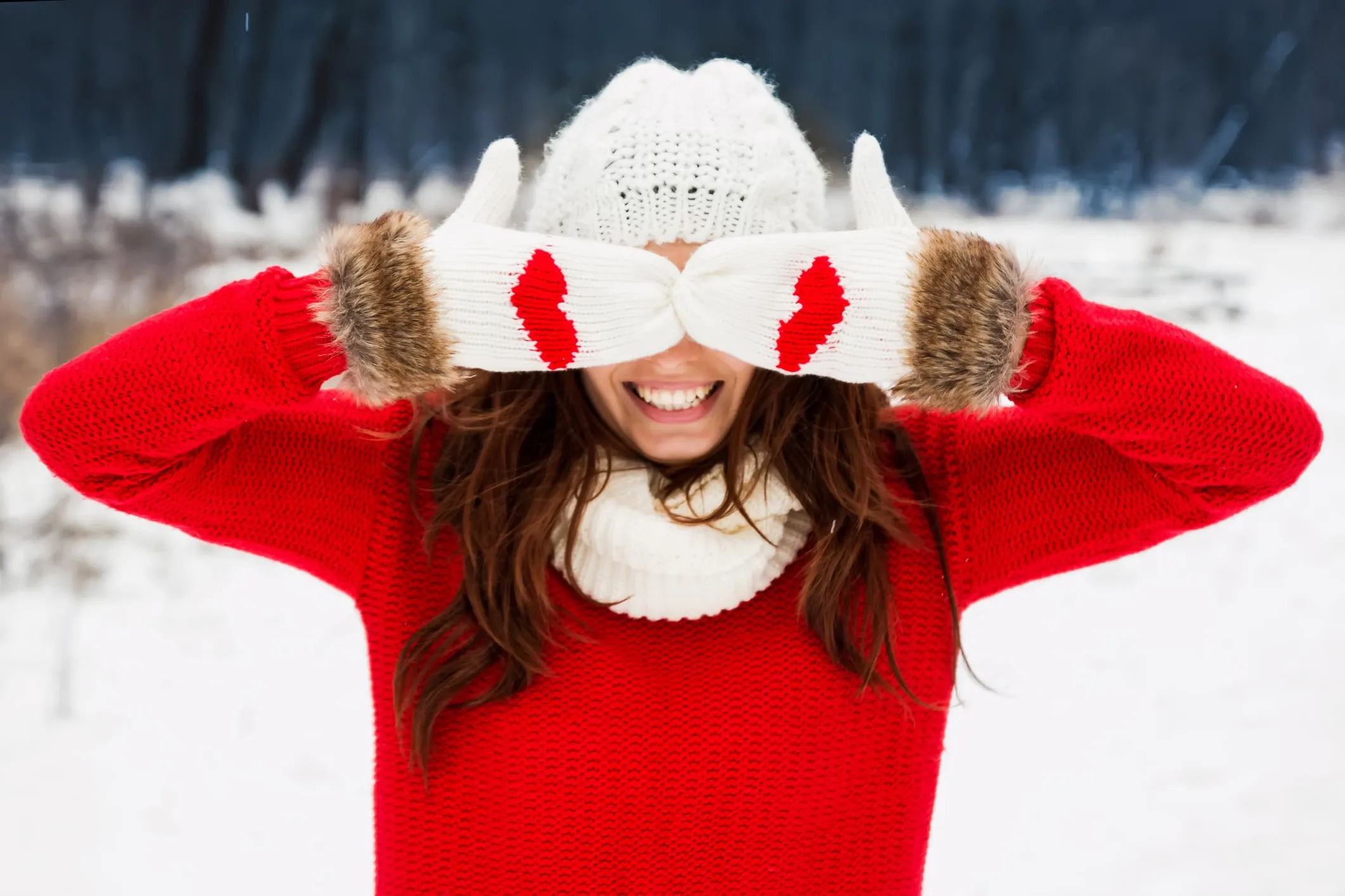 woman covering eyes in the snow