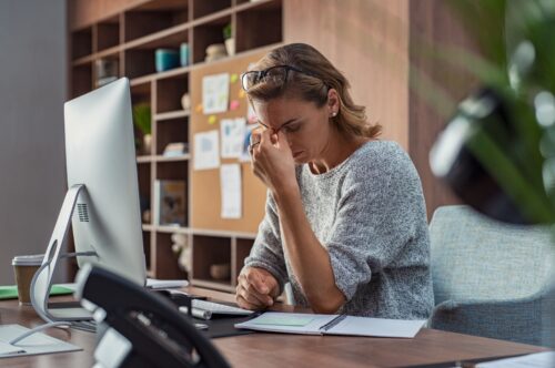woman stressed at desk scaled
