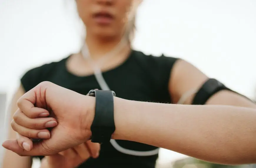 woman checks fitbit