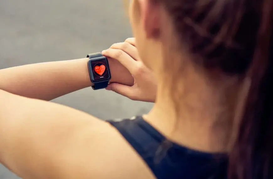 woman checks heart rate on watch