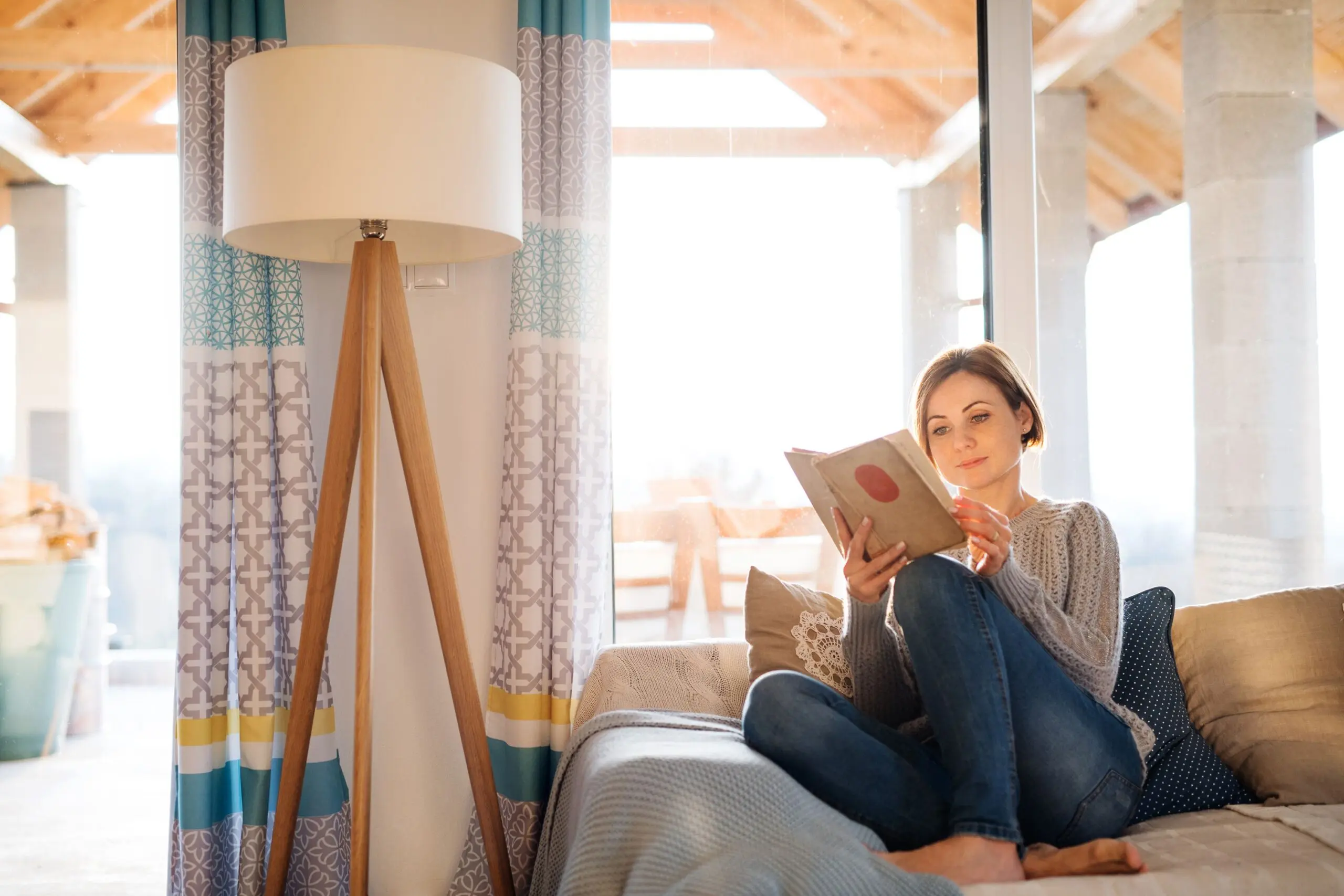 Woman sits reading a book scaled