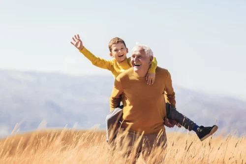 older couple run through fields scaled