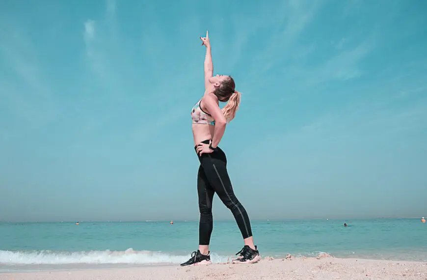 woman on beach points to the sky scaled