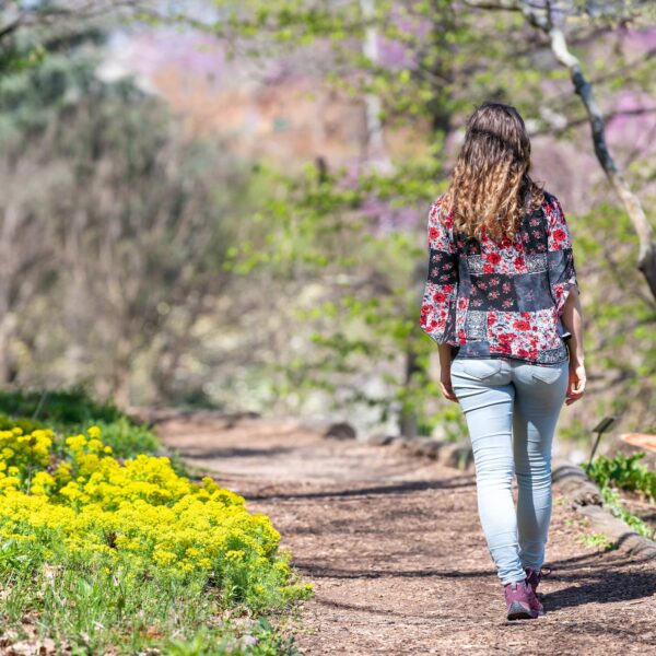 woman walks in woods