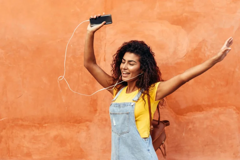 woman dancing wearing headphones scaled