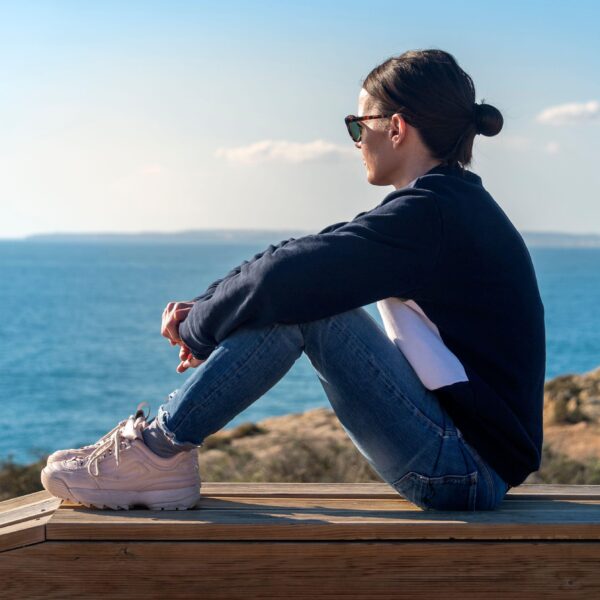 woman sits by the sea scaled