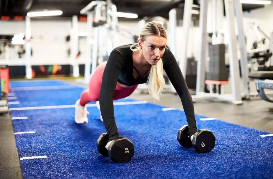 fit woman using dumbbells to do push ups scaled e1630001100682