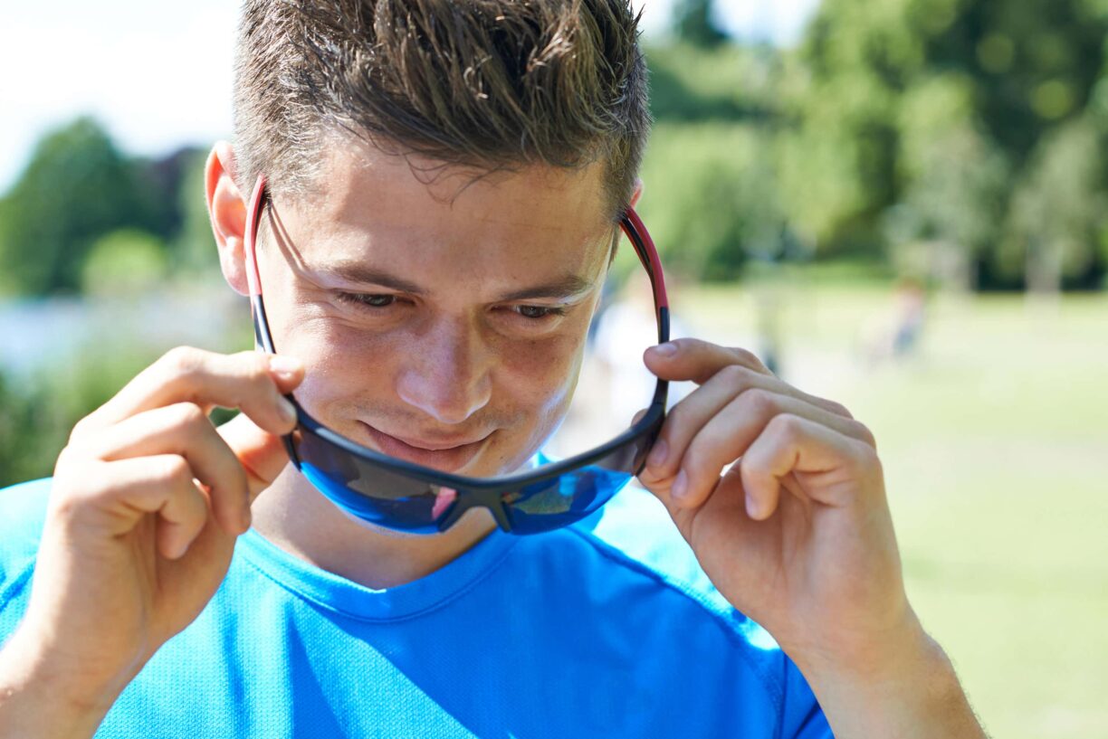 man with running glasses lowered