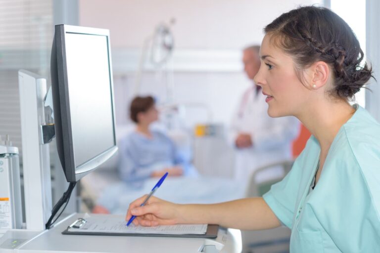 medical assistant looks at screen