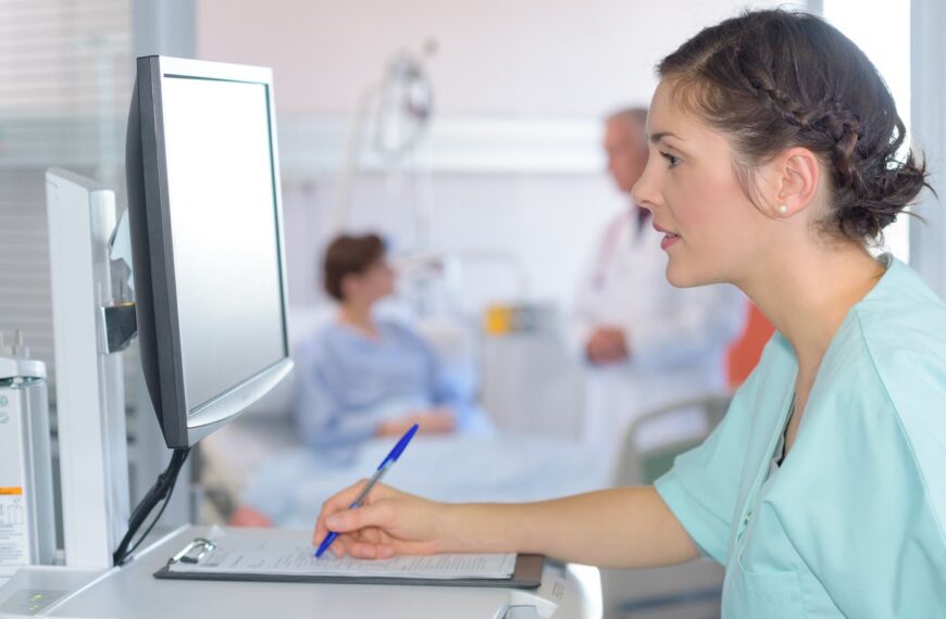 medical assistant looks at screen