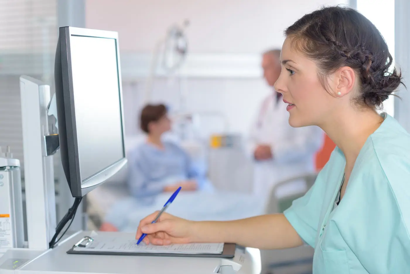 Medical assistant looks at screen