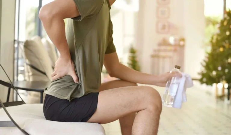 person sitting feels back in pain