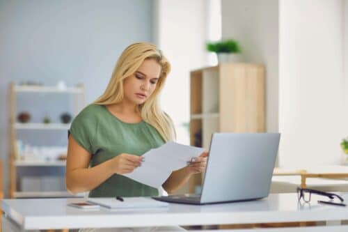 woman goes through paperwork scaled