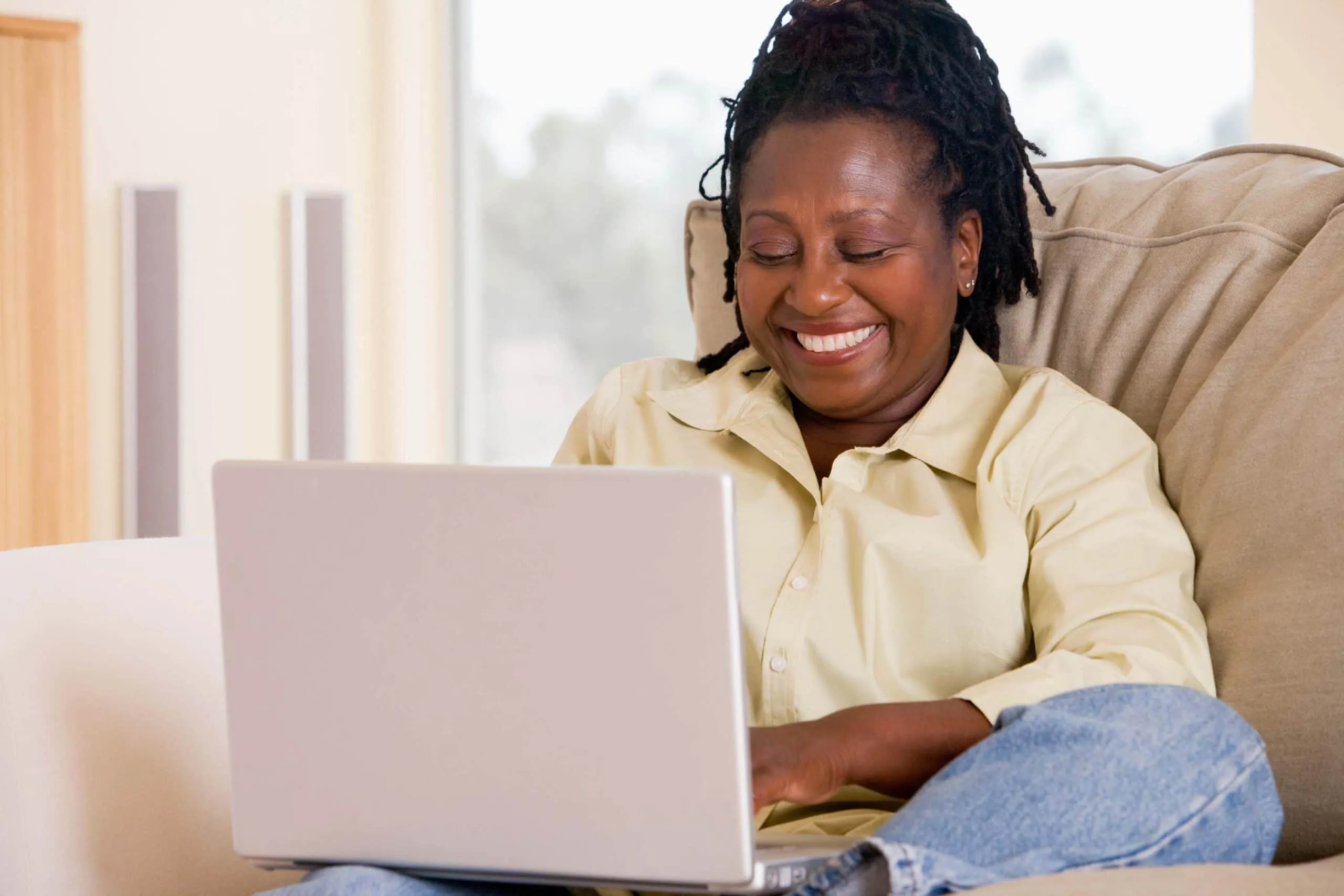 woman smiles on laptop