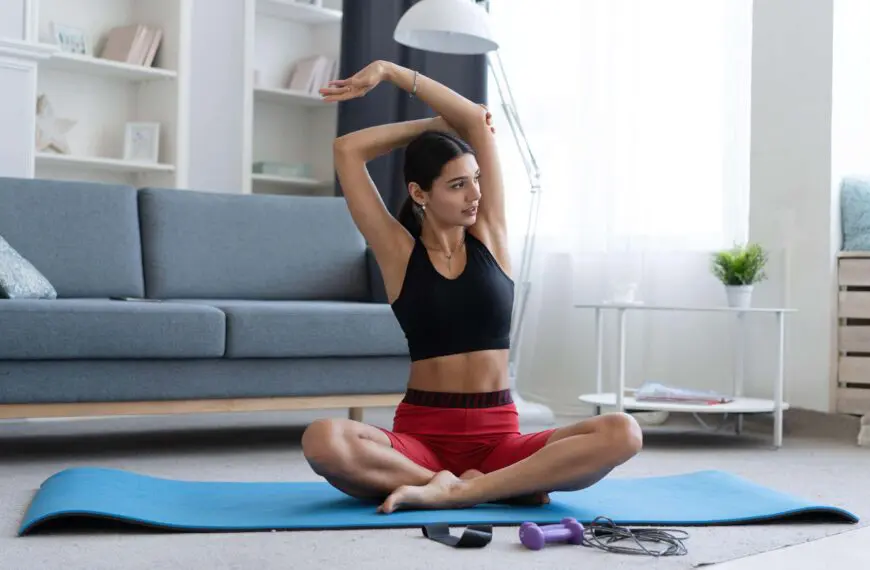 woman stretches on yoga mat scaled