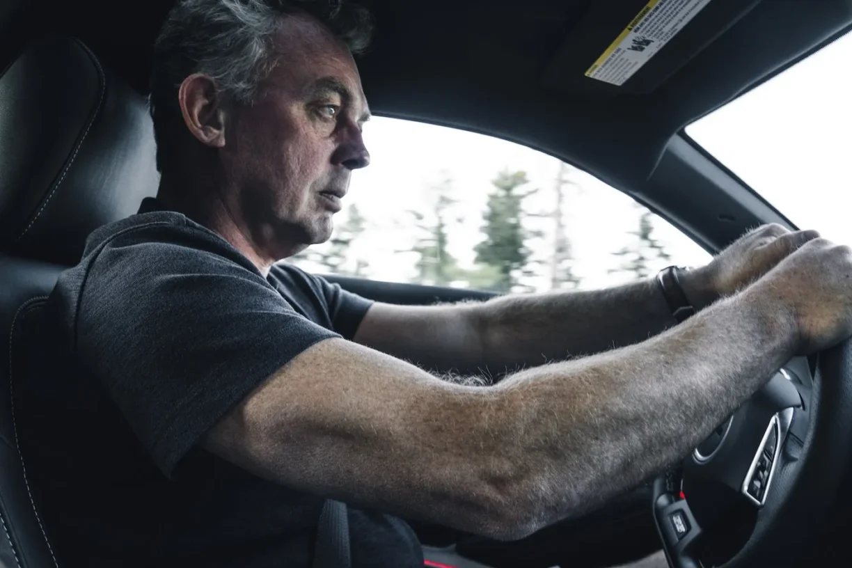 man looks nervous driving car
