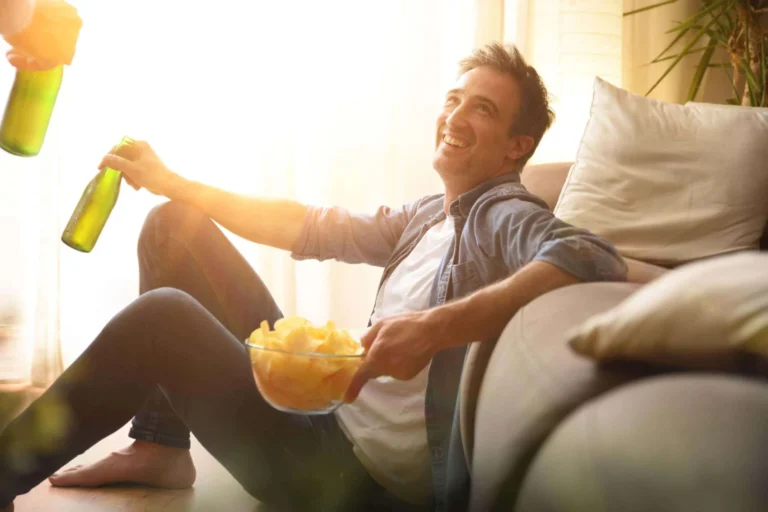 man sits with chips and beer scaled