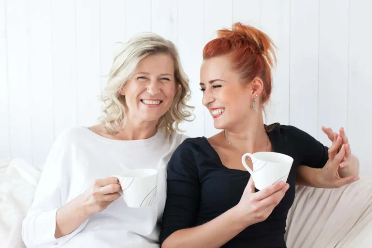mother and daughter share a laugh and cup of tea together scaled