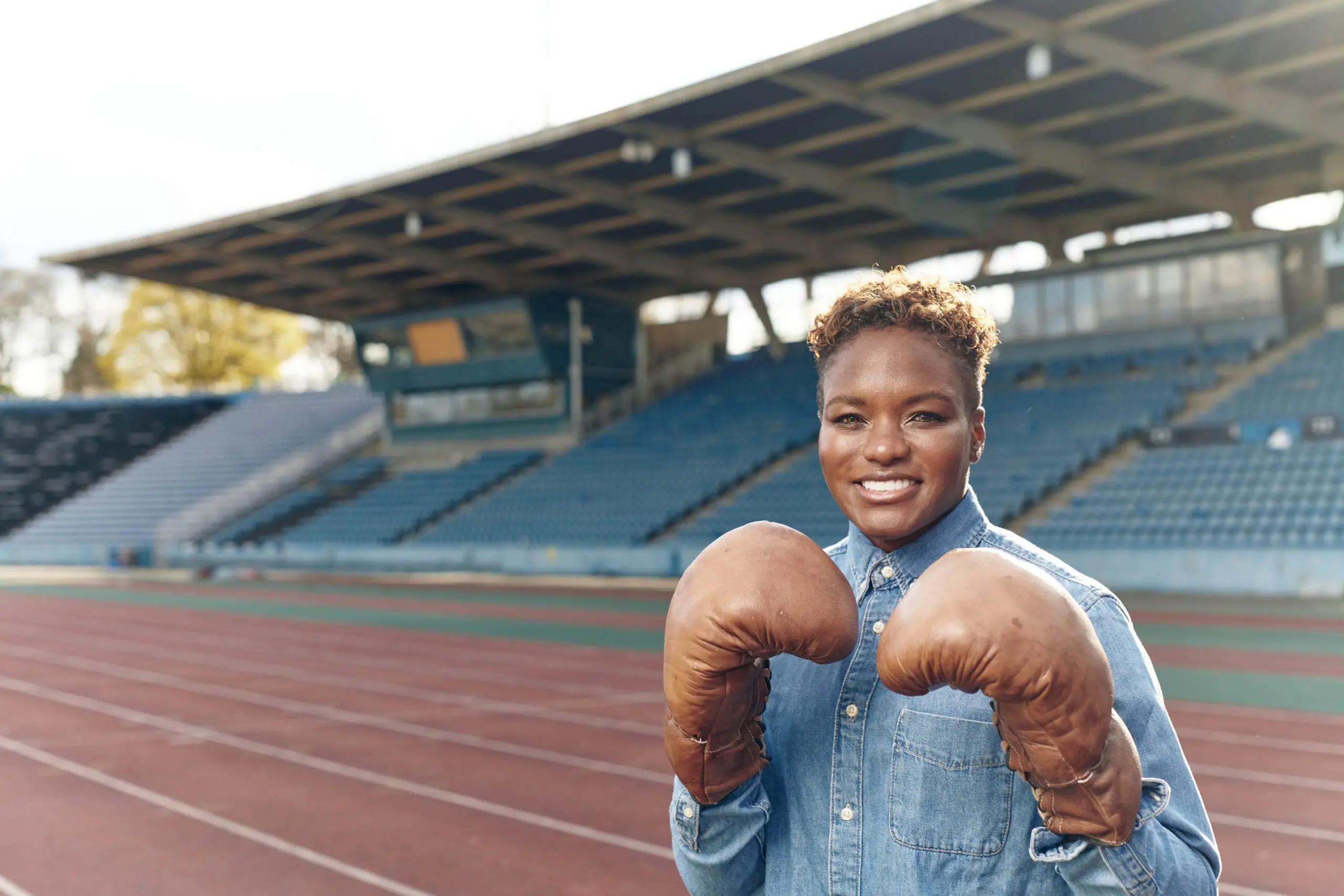 Nicola adams track side with boxing gloves on scaled