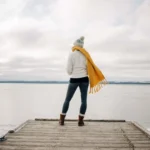 person stands at the edge of pontoon scaled