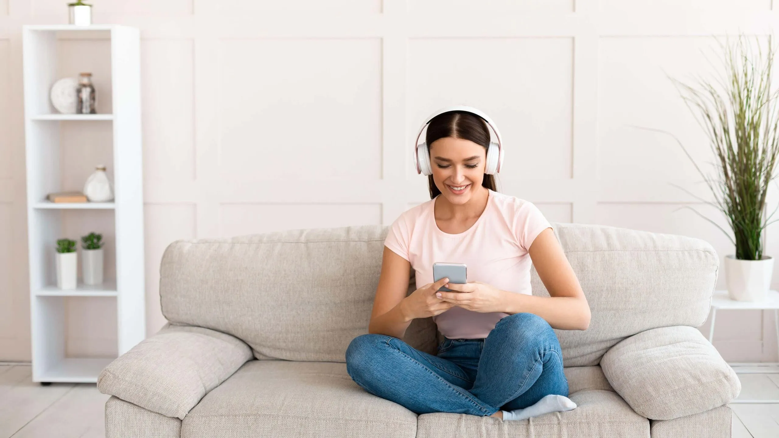 woman sits listening to podcast scaled
