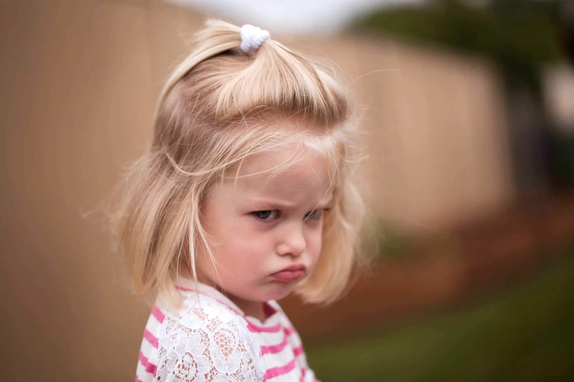 Young girl pulls a stroppy face