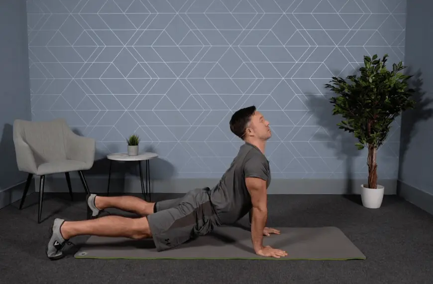 Fit man holds yoga position