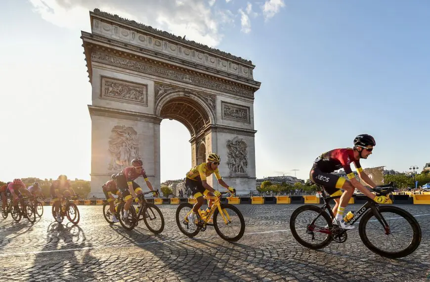 cyclists ride past the champs e lysees scaled