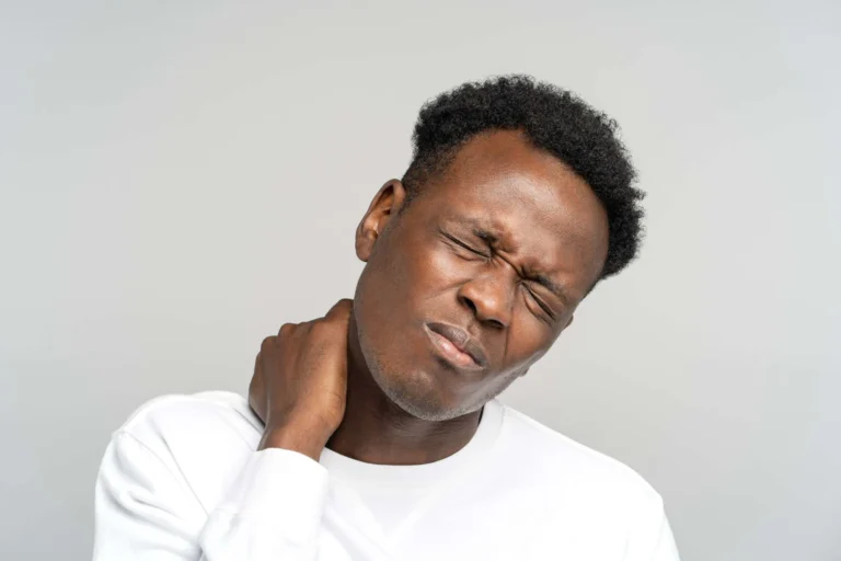 man holds neck in pain scaled