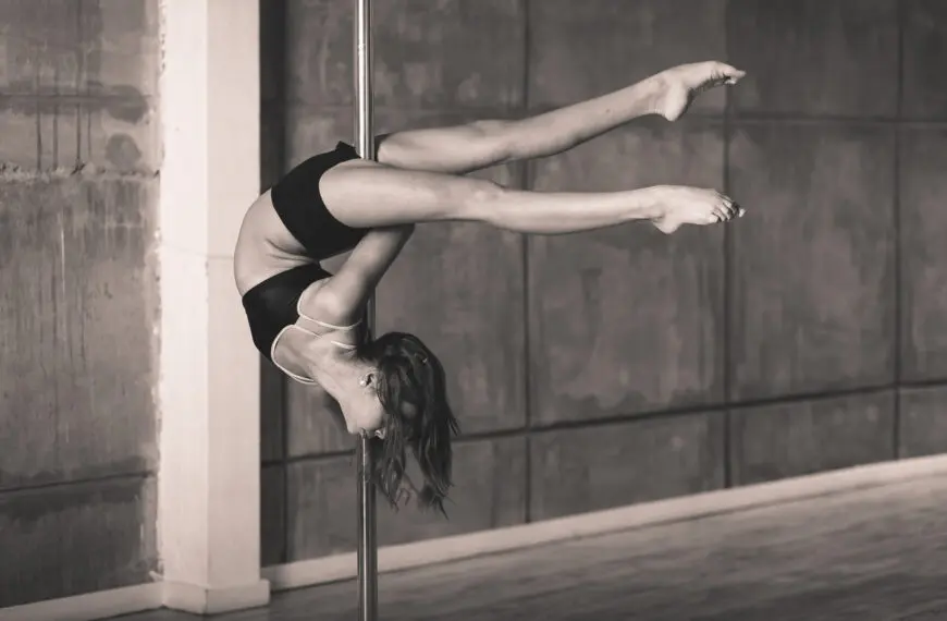 poledancer hangs upside down
