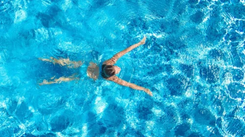 woman swims in pool